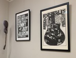 Guitar and Framed posters by University of Mississippi. Libraries. Archives and Special Collections.