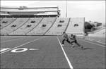 Boys Running on Football Field [University of Mississippi] by Nash Molpus